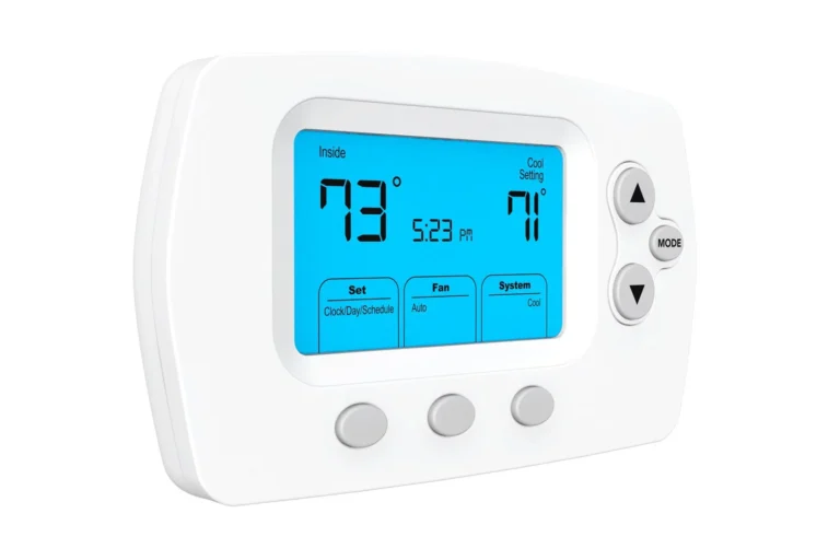 A digital thermostat displays an inside temperature of 73°F and a cool setting of 71°F, with controls and a blue backlit screen showing the time as 5:23 PM.