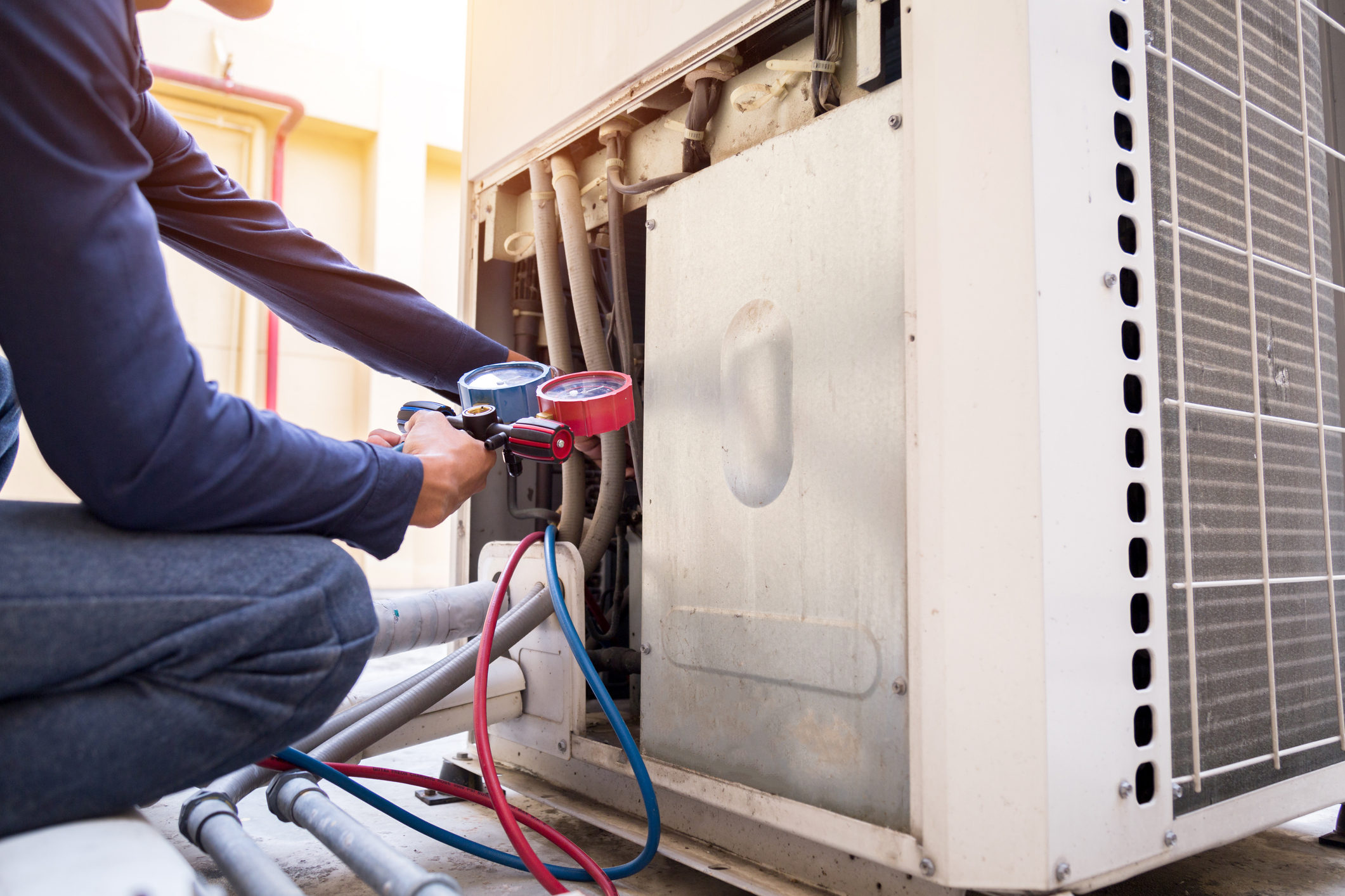 Technician is checking air conditioner, measuring equipment for filling air conditioners.