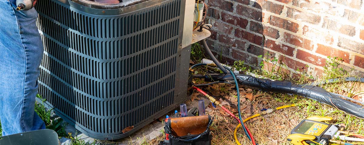 repairman fixing air conditioner